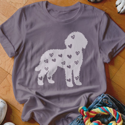 White poodle silhouette filled with small dark hearts on a purple t-shirt.