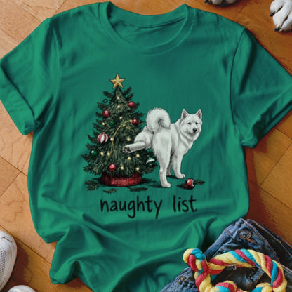 Green t-shirt featuring a white dog peeing on a decorated Christmas tree with the text naughty list.