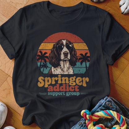 Black t-shirt featuring a retro graphic of an English Springer Spaniel wearing sunglasses against a sunset.
