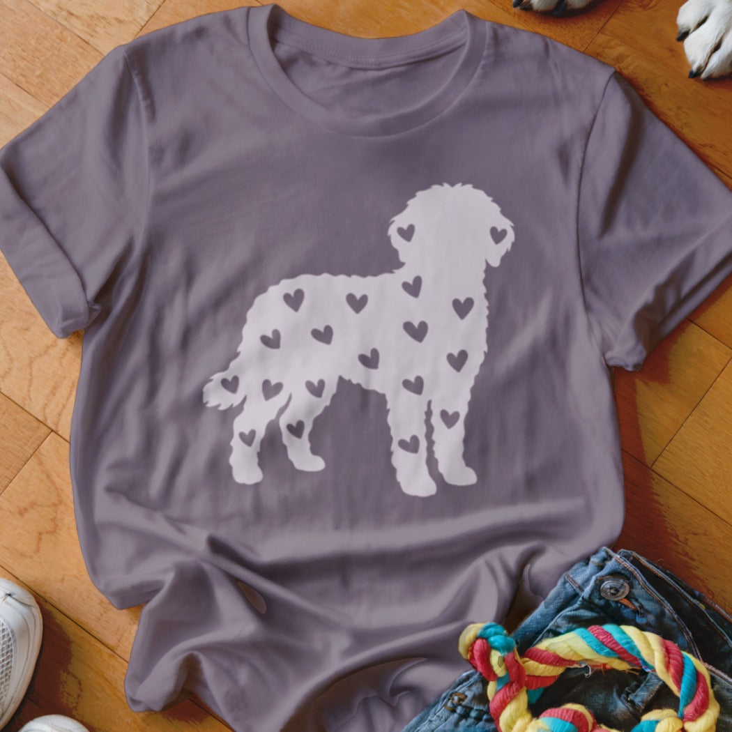 White dog silhouette filled with dark hearts on a purple t-shirt.