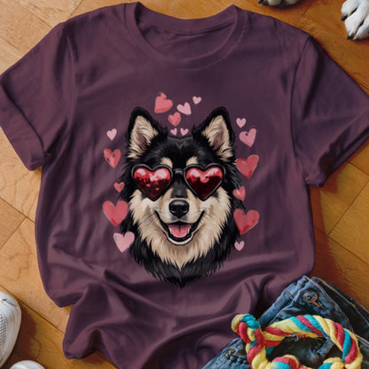 A dark purple t-shirt featuring an illustration of a black and tan dog wearing heart-shaped sunglasses, surrounded by pink hearts.
