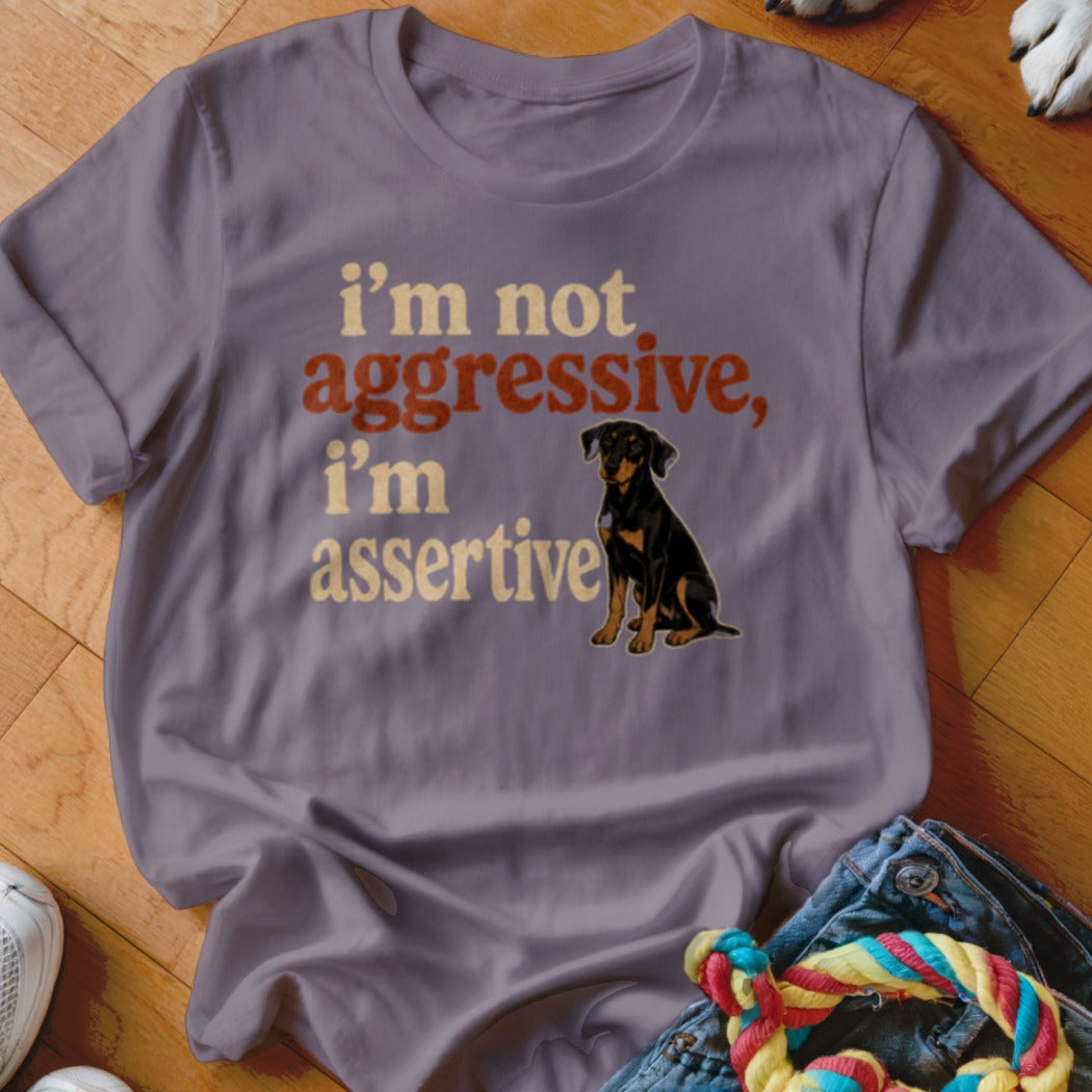 Purple t-shirt with a black and tan dog and text "i'm not aggressive, i'm assertive".