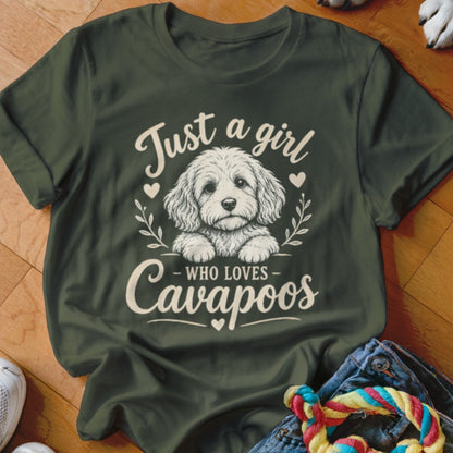 Green t-shirt with a white illustration of a Cavapoo dog and text saying "Just a girl WHO LOVES Cavapoos".