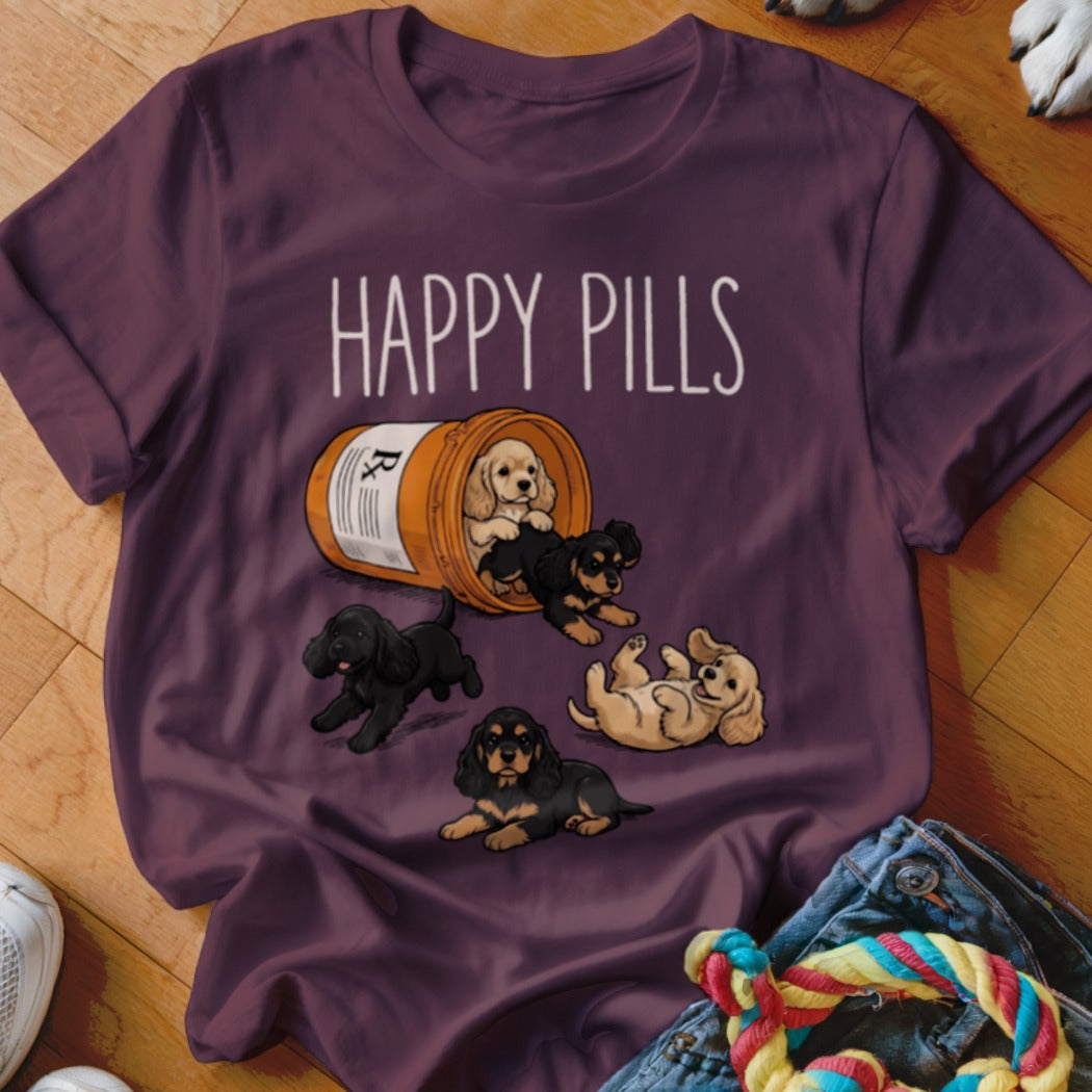 T-shirt with cartoon puppies spilling from a pill bottle, reading "HAPPY PILLS".