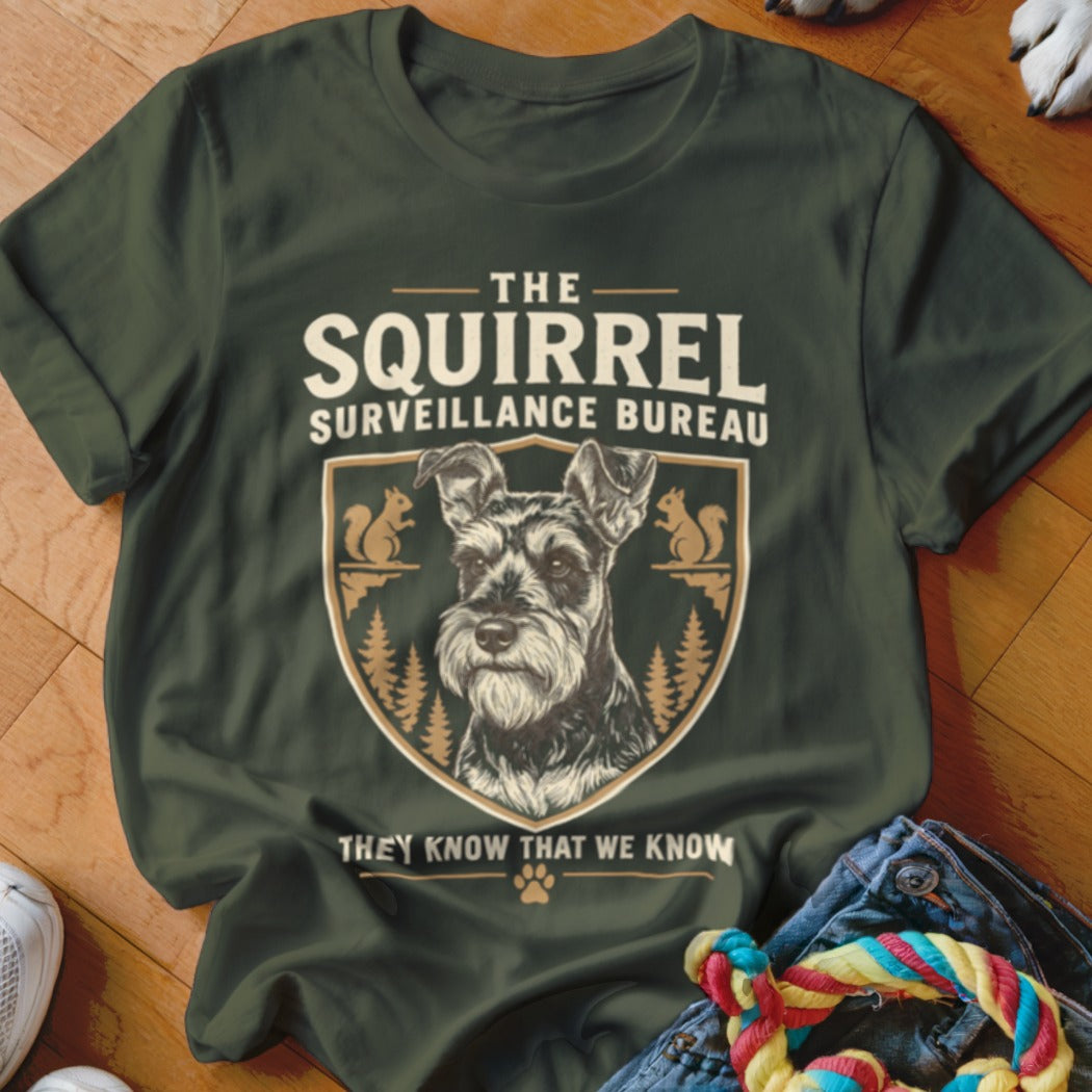 Dark green t-shirt with text reading The Squirrel Surveillance Bureau and a schnauzer graphic.