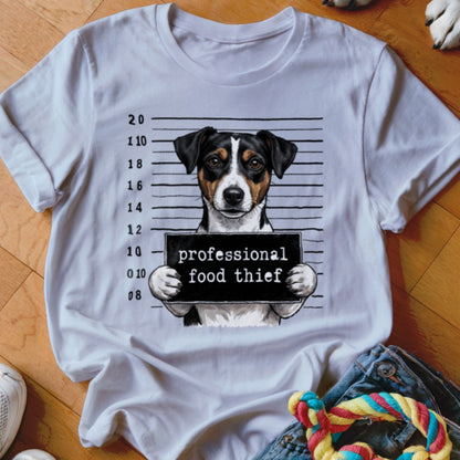 Dog mugshot with sign reading "professional food thief" on white t-shirt.