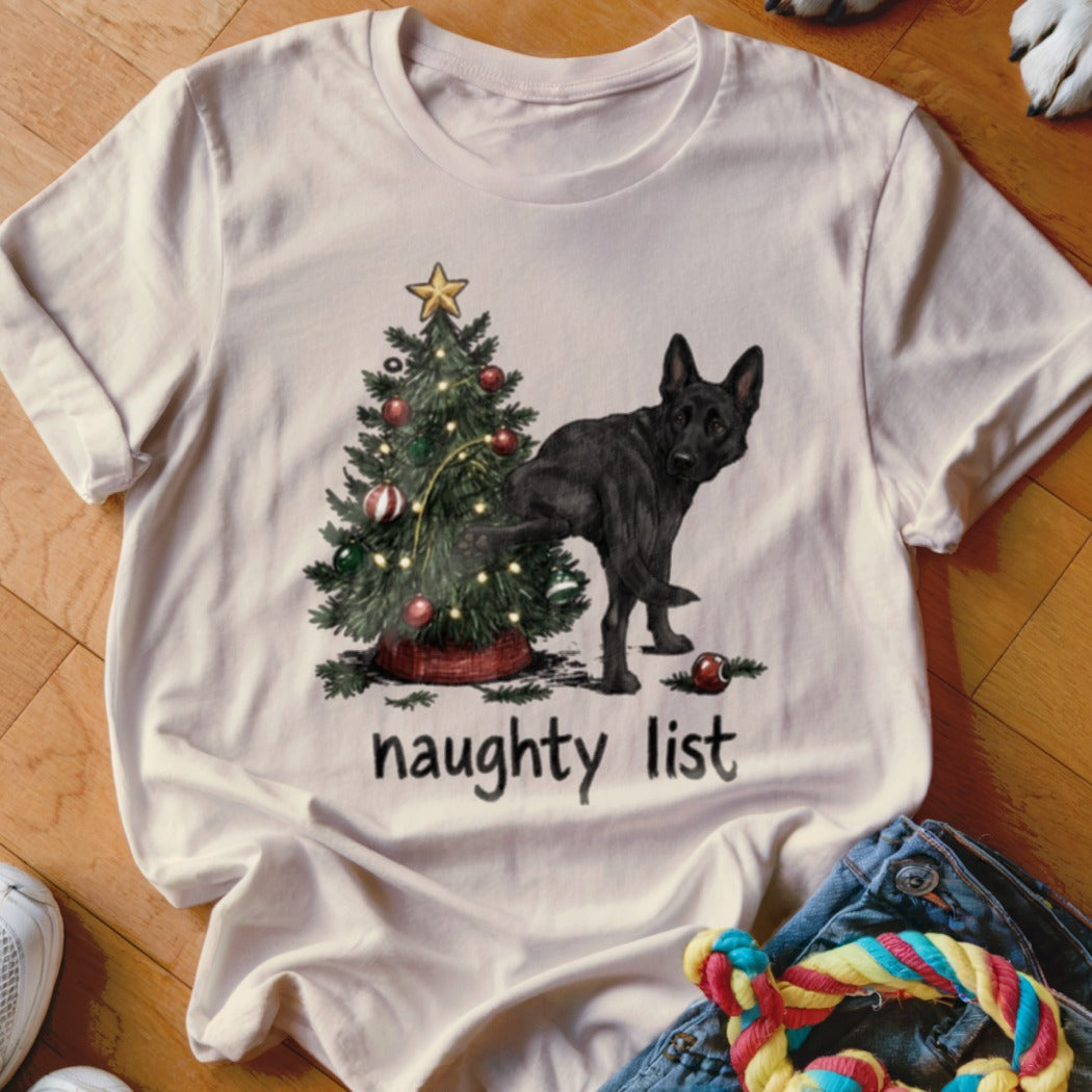Black German Shepherd next to a Christmas tree with text "naughty list".