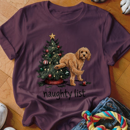 Golden doodle dog near Christmas tree with "naughty list" text.