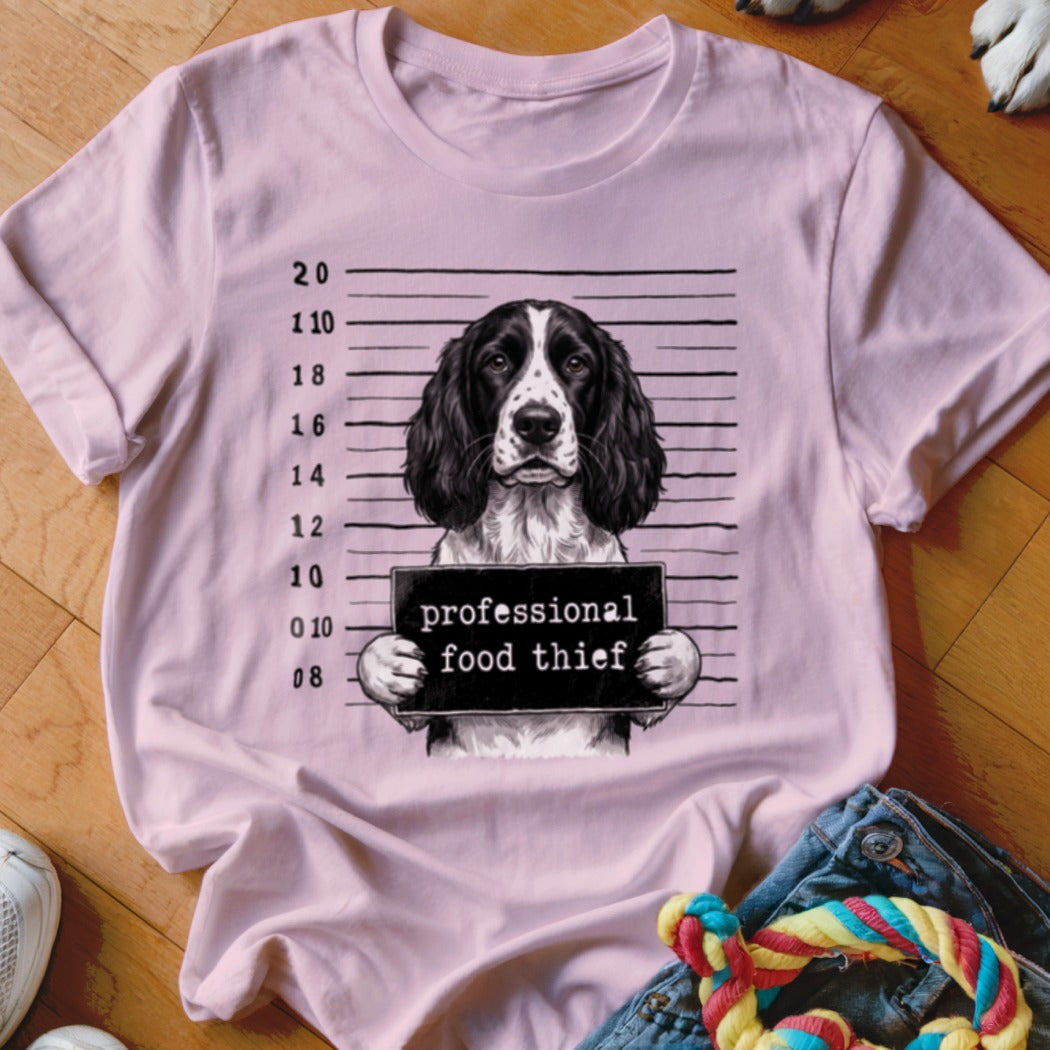 English Springer Spaniel mugshot with "professional food thief" sign.