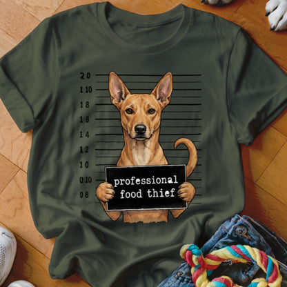 Dog in mugshot holding sign that says "professional food thief"