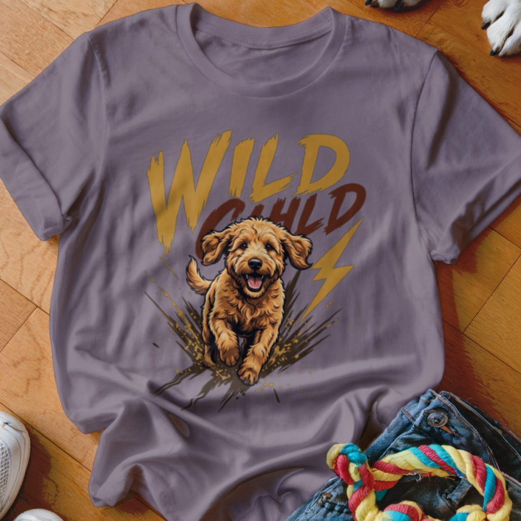 A purple t-shirt featuring a graphic of a running golden doodle and the text Wild Child.