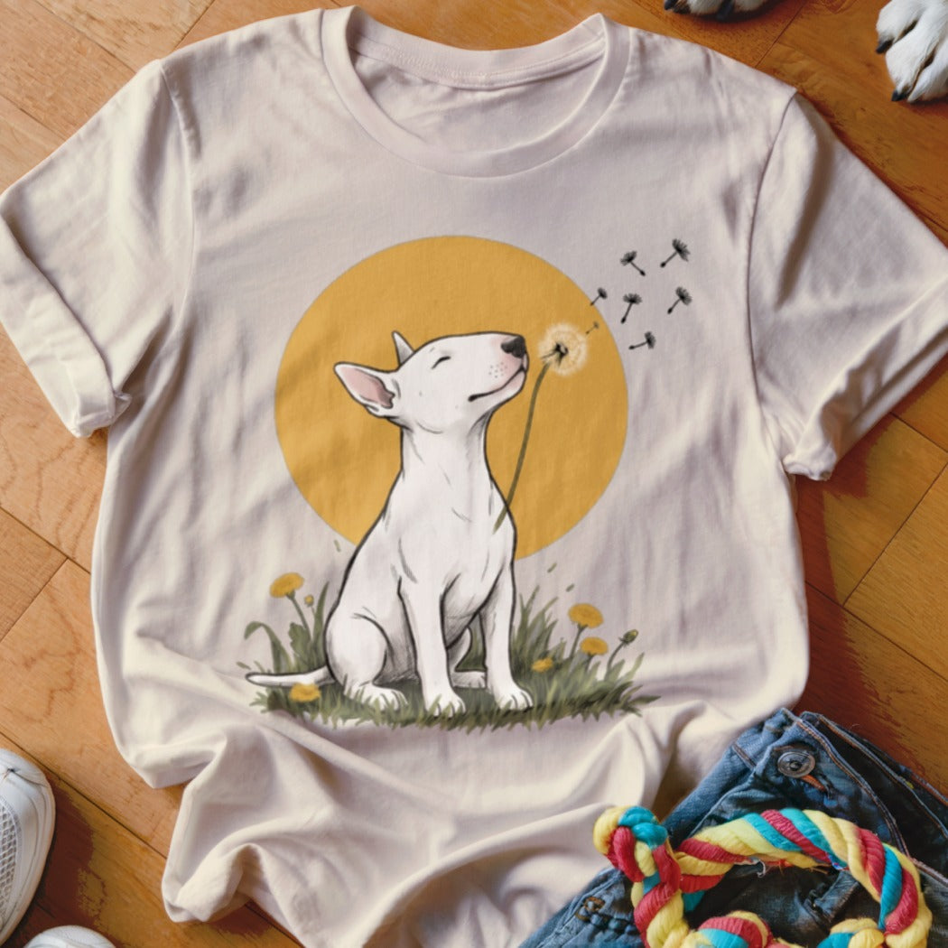 Off-white short-sleeve t-shirt featuring an illustration of a white bull terrier blowing dandelion seeds.