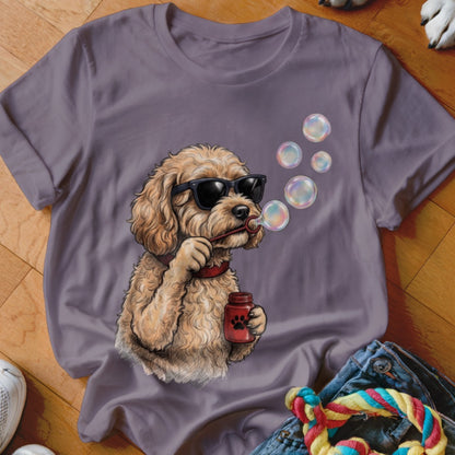 A purple t-shirt featuring a graphic of a fluffy dog wearing sunglasses and blowing bubbles.