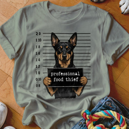 Dog in mugshot holding sign that says "professional food thief".