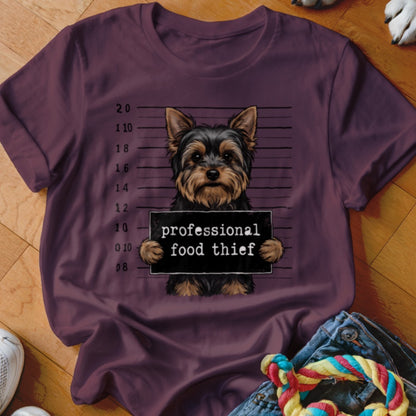 Yorkshire terrier mugshot with text "professional food thief" on shirt.