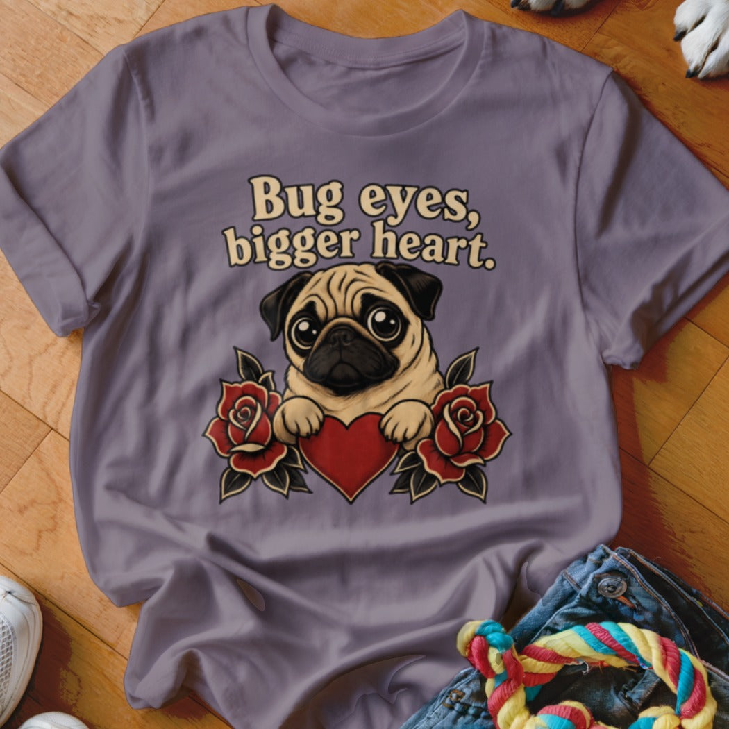Pug with heart and roses graphic on a purple t-shirt reading "Bug eyes, bigger heart."