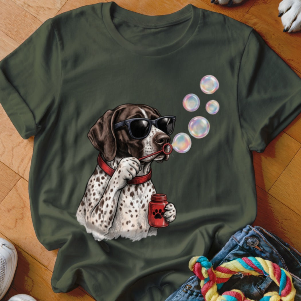 Olive green t-shirt featuring a graphic of a spotted dog wearing sunglasses and blowing bubbles.