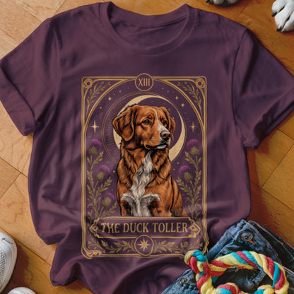 Maroon t-shirt featuring a tarot-style graphic of a Duck Toller dog, crescent moon, and flowers.
