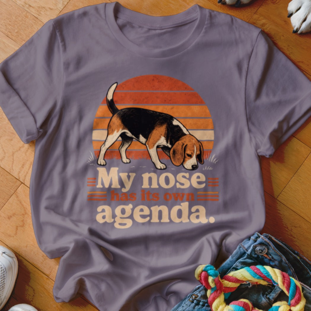 Purple t-shirt with beagle sniffing ground and text "My nose has its own agenda."