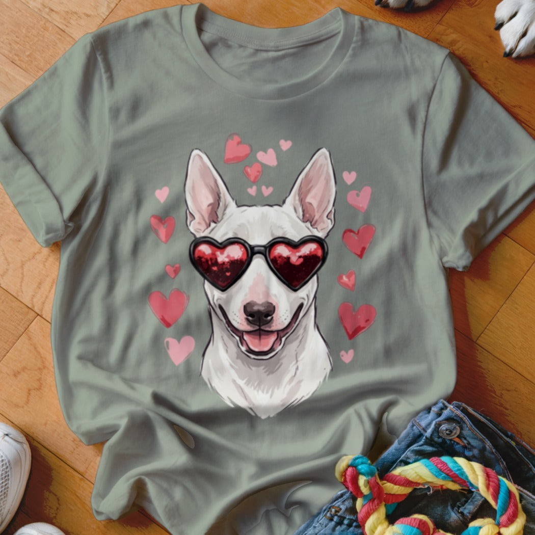 Sage green t-shirt featuring a graphic of a white bull terrier wearing heart-shaped sunglasses surrounded by pink hearts.