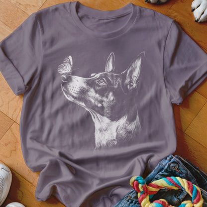 A grey crewneck t-shirt featuring a white sketch graphic of a dog looking at a butterfly on its nose.