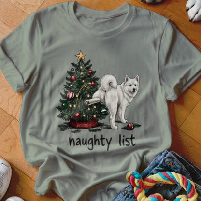 A gray t-shirt features an illustration of a white dog lifting its leg against a decorated Christmas tree, with the text "naughty list" below.