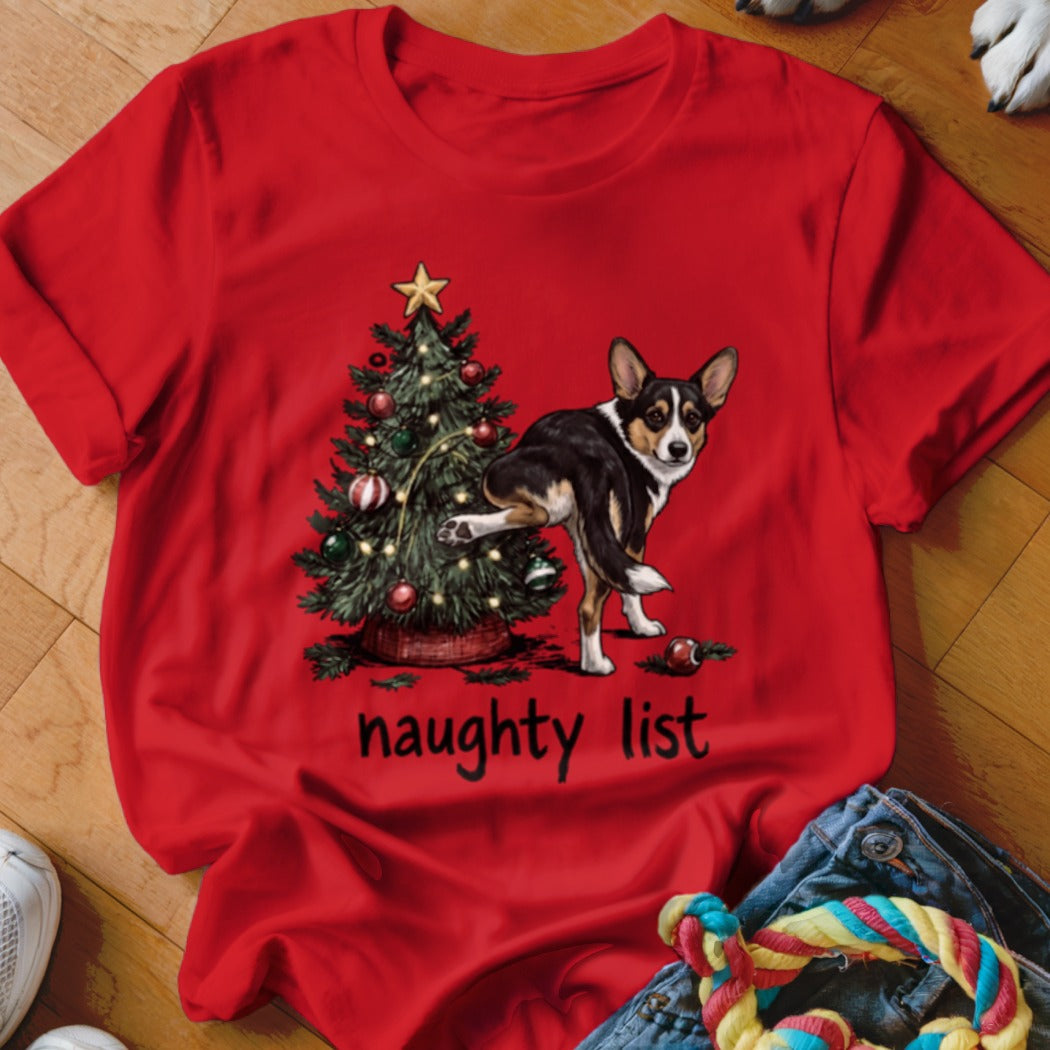 Red t-shirt with a Corgi peeing on a Christmas tree, text reads "naughty list".