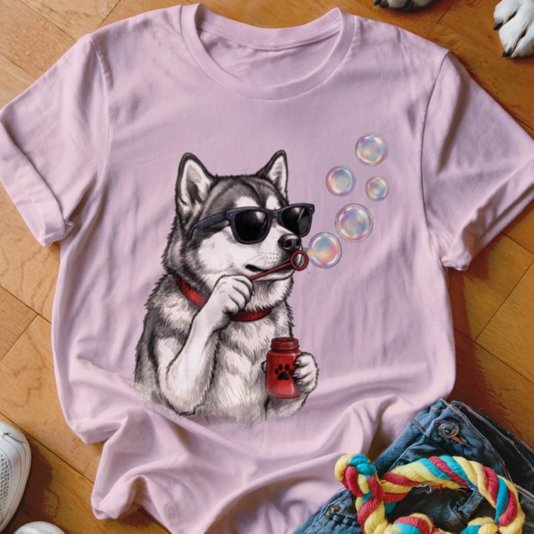 Light pink t-shirt featuring a graphic of a husky wearing sunglasses and blowing soap bubbles.