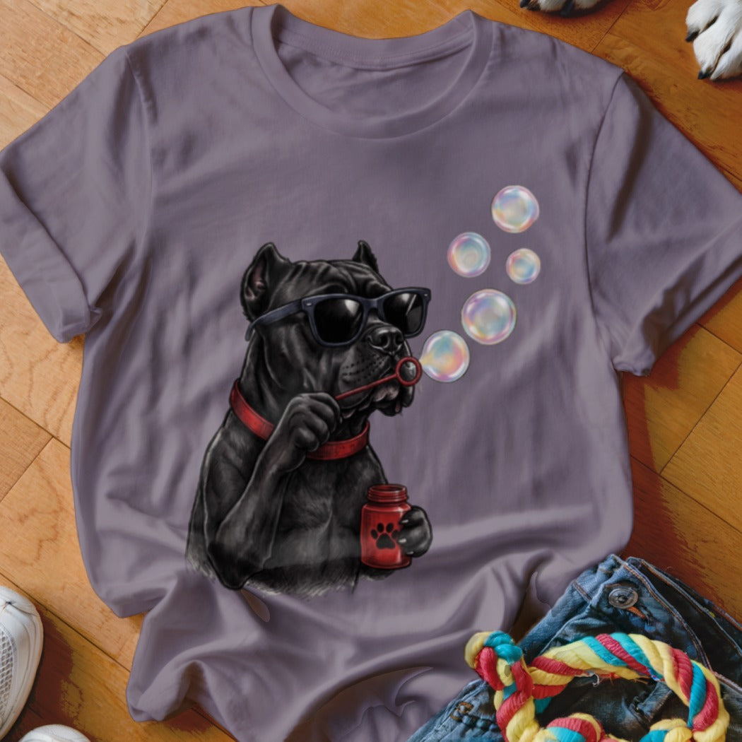 A grey t-shirt featuring a graphic of a black dog wearing sunglasses and blowing bubbles.