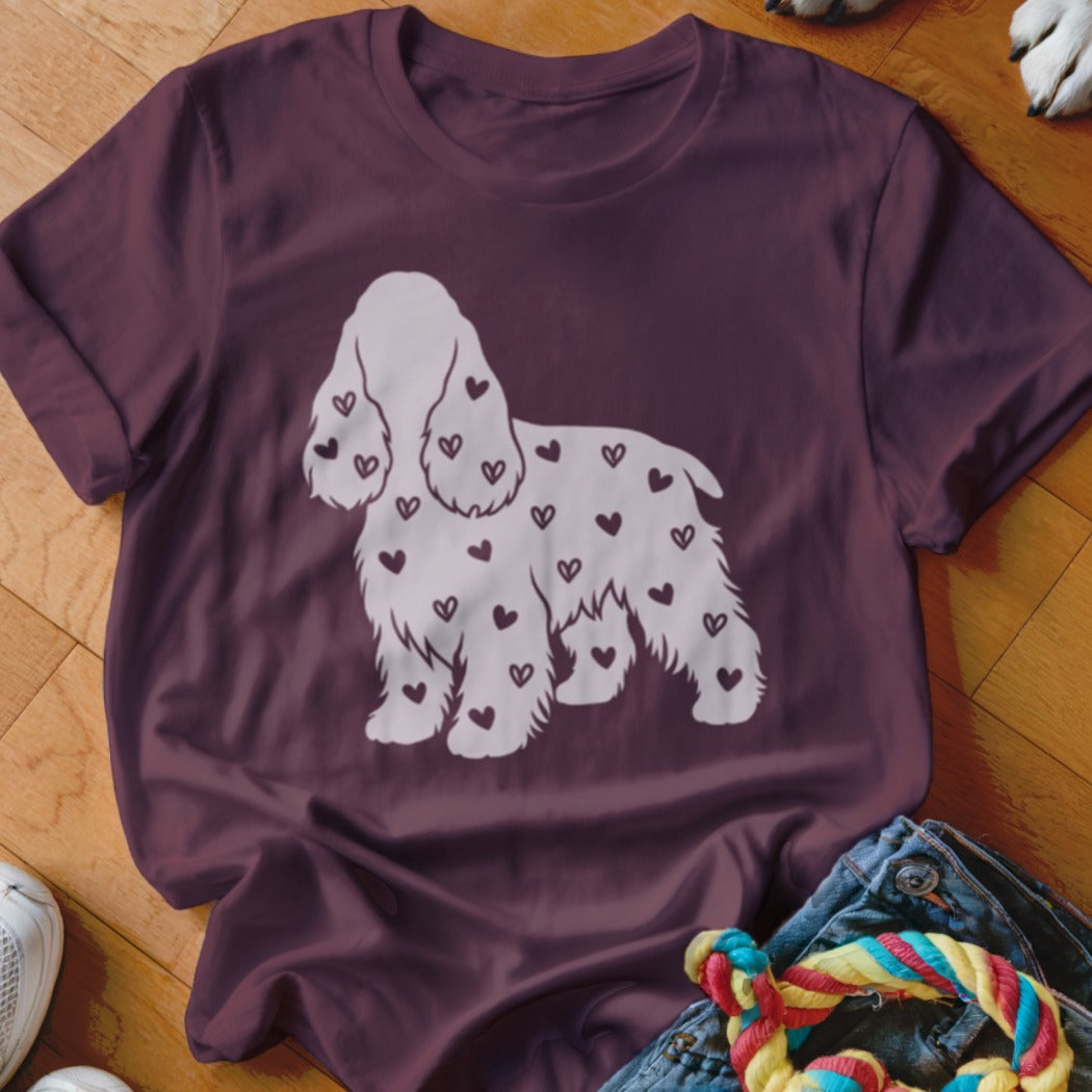Burgundy t-shirt with white dog silhouette covered in small hearts.