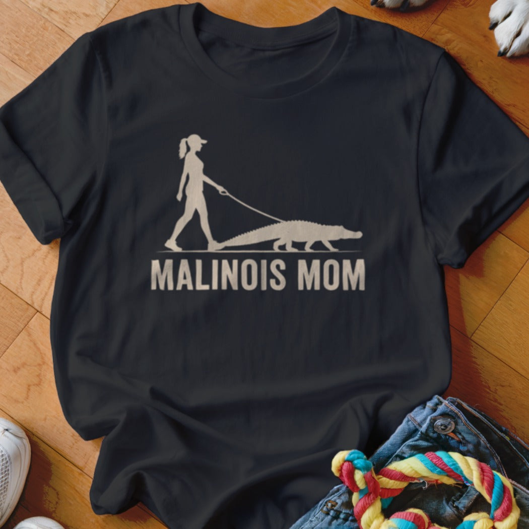 Silhouetted woman walking an alligator with text "MALINOIS MOM" on black t-shirt.