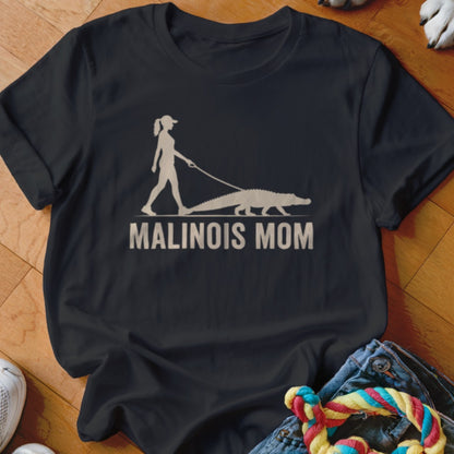 Silhouetted woman walking an alligator with text "MALINOIS MOM" on black t-shirt.