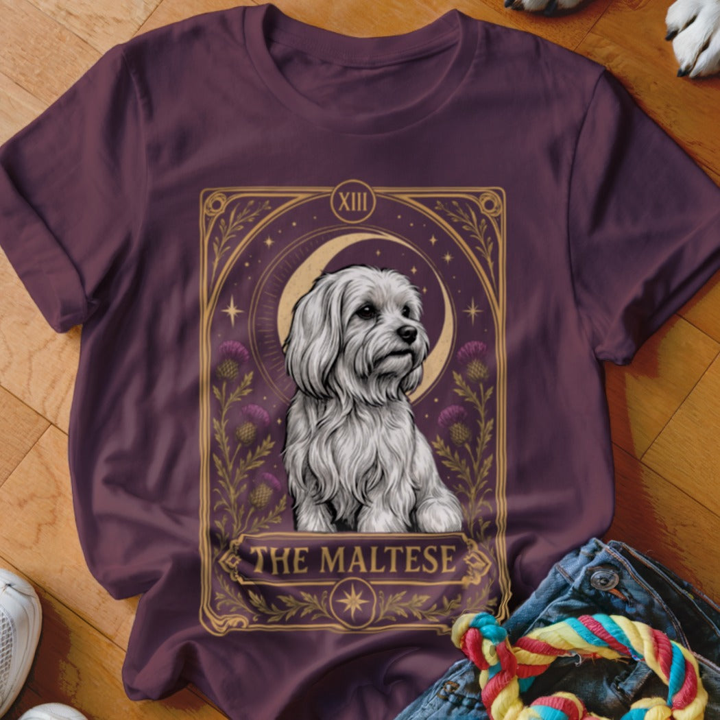 Dark purple t-shirt featuring a tarot card style graphic of a white Maltese dog.