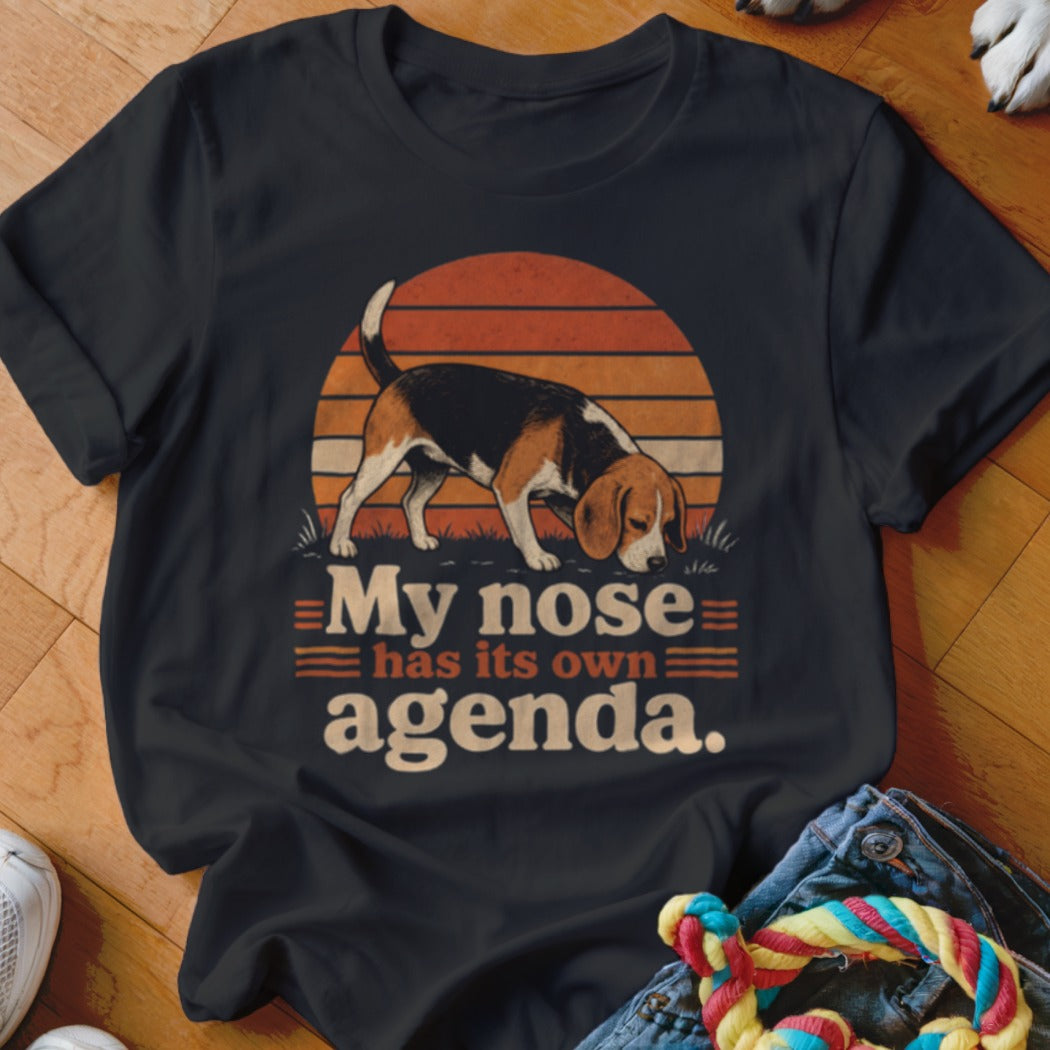 Beagle dog with text "My nose has its own agenda." on dark t-shirt.
