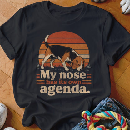 Beagle dog with text "My nose has its own agenda." on dark t-shirt.