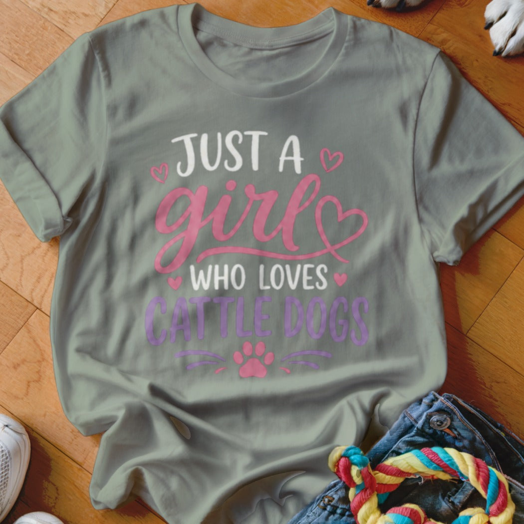 Gray t-shirt with white and pink text reading "JUST A girl WHO LOVES CATTLE DOGS".