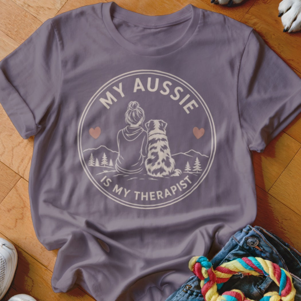 Purple t-shirt featuring a circular graphic of a person and an Australian Shepherd, with text "My Aussie Is My Therapist".