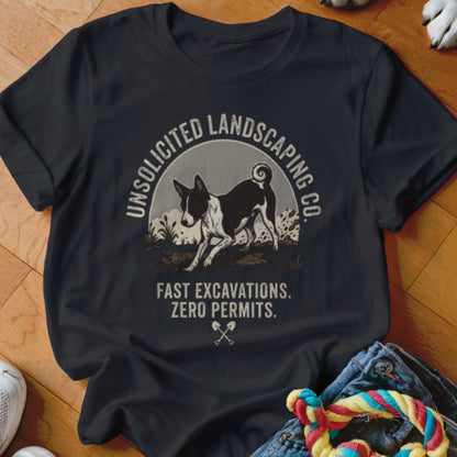 Black t-shirt with graphic of a dog digging, text reads "Unsolicited Landscaping Co. Fast Excavations. Zero Permits."