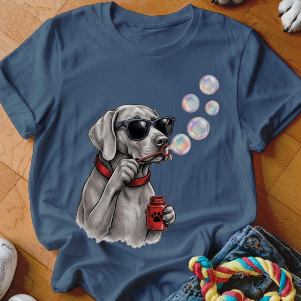 A blue t-shirt printed with a graphic of a dog wearing sunglasses and blowing bubbles.