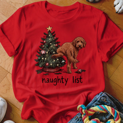 Red t-shirt with dog by Christmas tree and "naughty list" text.