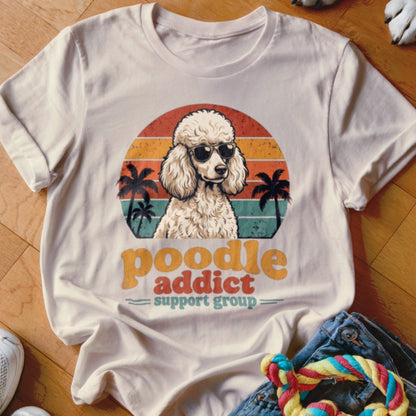 Cream t-shirt featuring a retro graphic of a poodle wearing sunglasses with the text poodle addict support group.