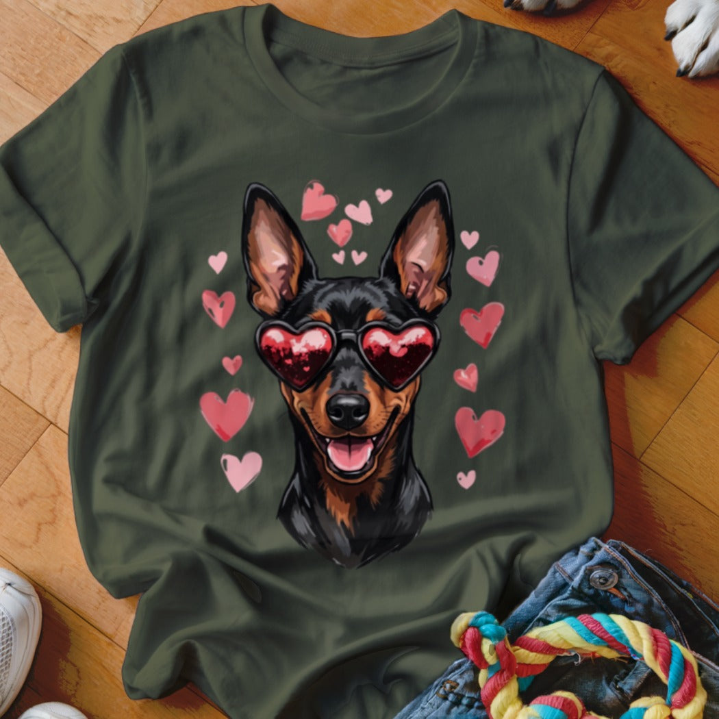 Dark green t-shirt featuring a graphic of a black dog wearing heart-shaped sunglasses surrounded by floating pink hearts.