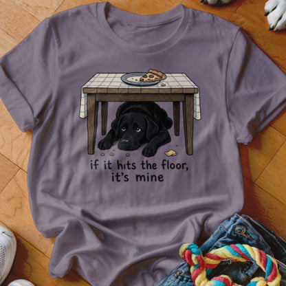 Black lab hiding under table with pizza, "if it hits the floor, it's mine."