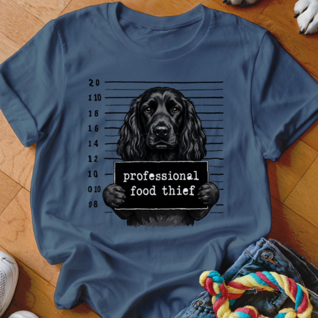 Black dog mugshot with "professional food thief" sign and height chart.