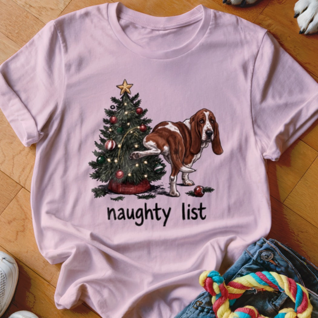 Basset Hound near a Christmas tree, peeing on it, with text "naughty list".