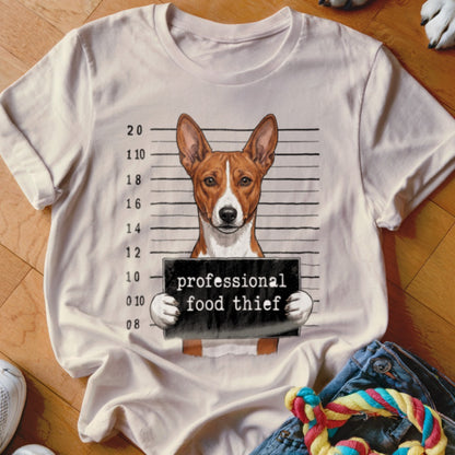 Basenji dog mugshot on a t-shirt reads "professional food thief".