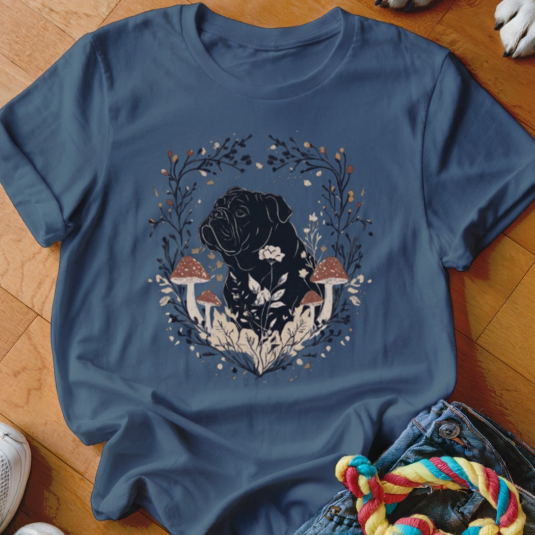 Blue t-shirt featuring a graphic of a black dog surrounded by botanical illustrations and mushrooms.