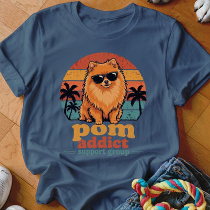 Blue crewneck t-shirt featuring a Pomeranian wearing sunglasses against a sunset graphic and palm trees.