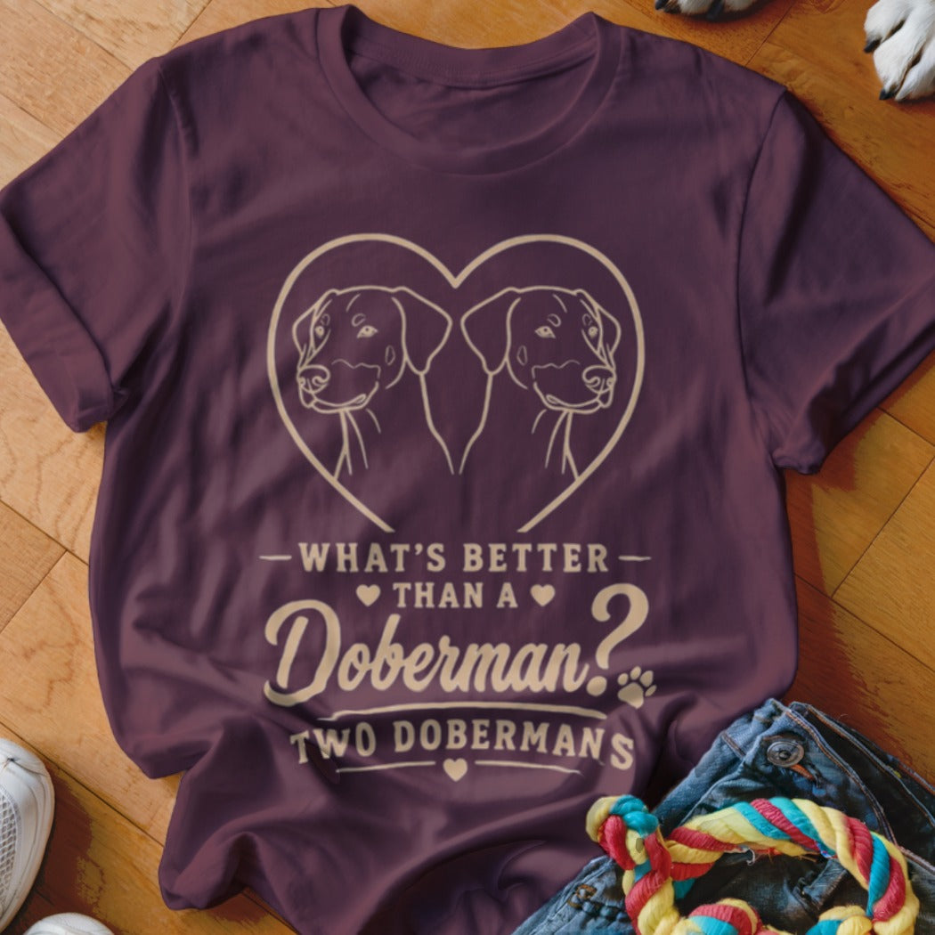 Maroon t-shirt with heart containing two Dobermans, text "What's better than a Doberman? Two Dobermans."