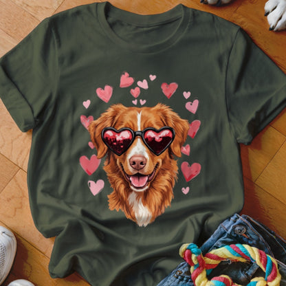 A dark green t-shirt featuring a graphic of a golden retriever wearing heart-shaped sunglasses surrounded by pink hearts.